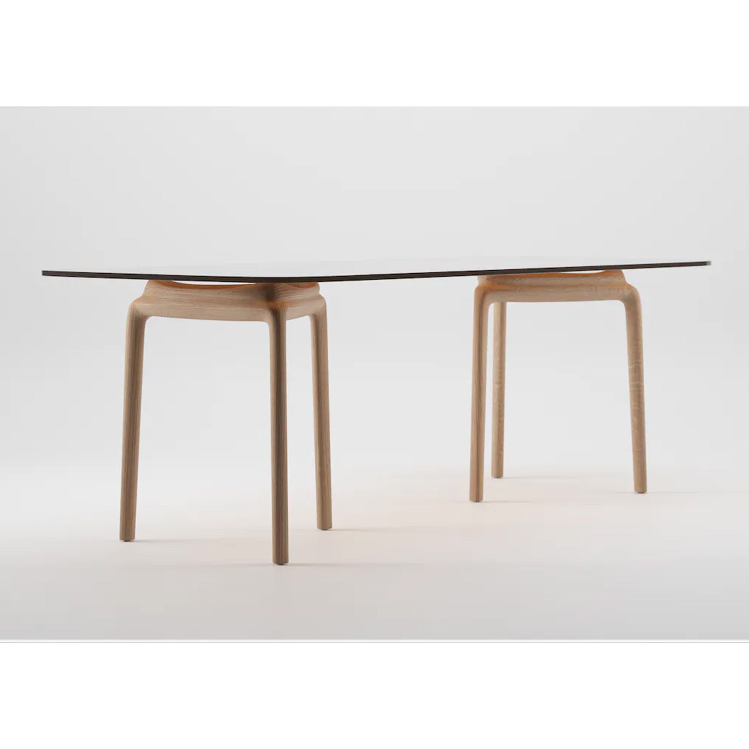 The PASCAL Rectangular Table by Artisan is a minimalist design featuring a thin, dark tabletop with smooth, rounded edges, supported by two solid wood stands with natural texture. Its sleek modern aesthetic gives it a balanced, suspended look.