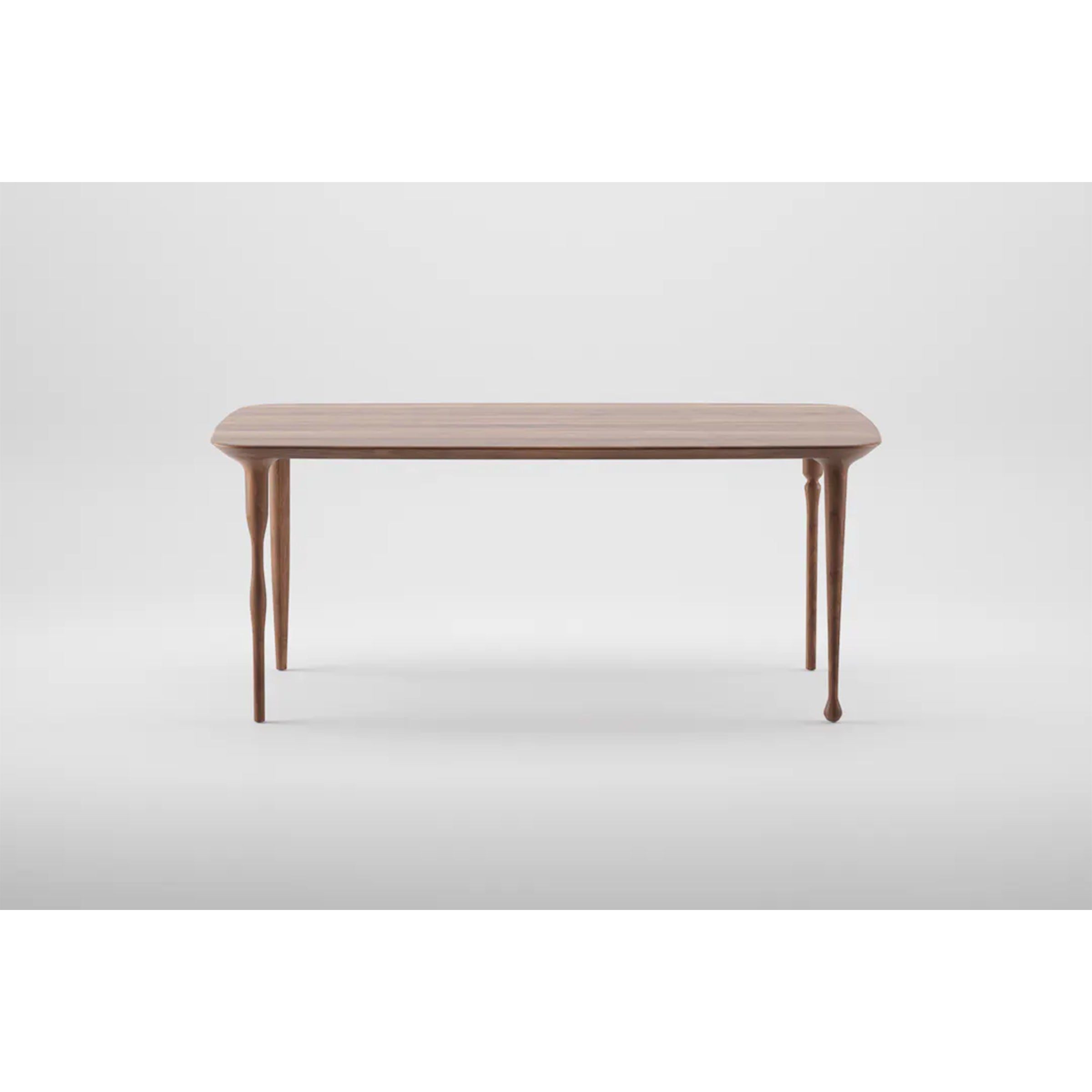 The PASHA Table by Artisan features a smooth rectangular wooden top and four slender, elegantly tapered legs, set against a plain white background.