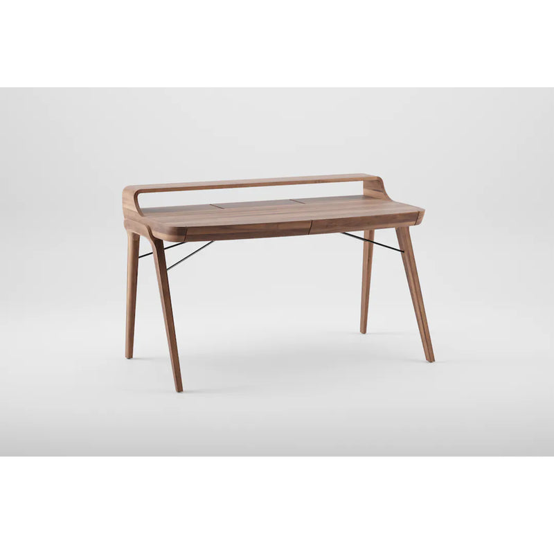 The PICARD Desk by Artisan is a sleek solid wood desk with a raised shelf and minimalist design. It features slim tapered legs, metal supports, a smooth finish, clean lines, and modern aesthetics set against a plain white background.