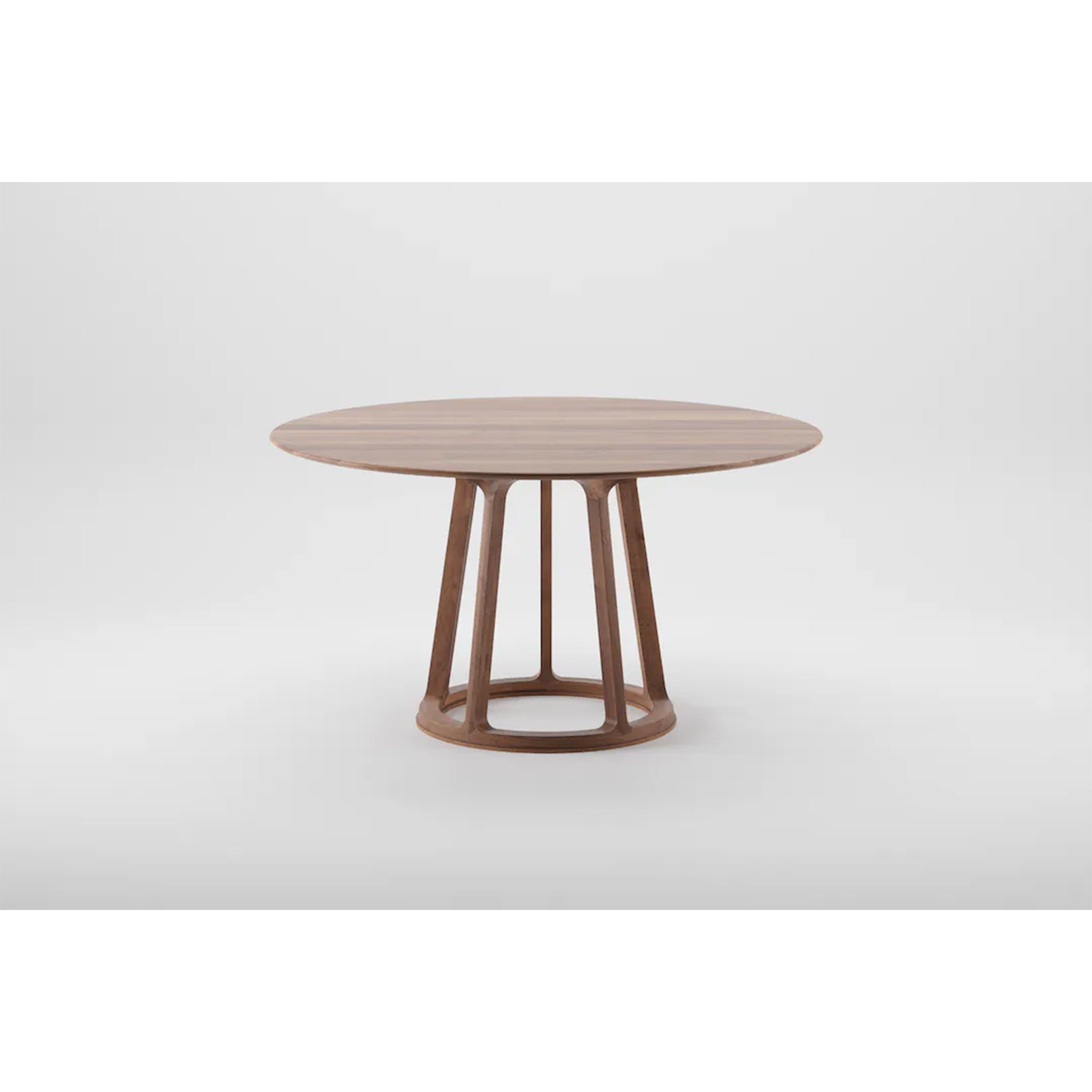 The PIVOT Round Table by Artisan features a solid wood top and geometric base with four angled legs connected by a circular support, crafted from eco-friendly materials and natural oils, set against a plain light gray background.