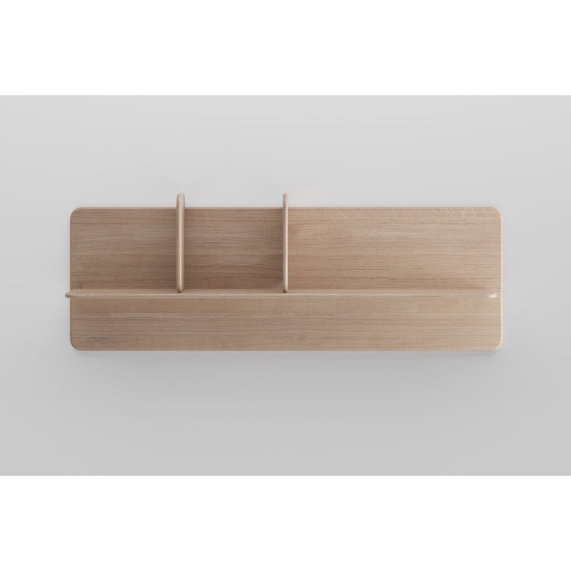 The Artisan Soft Wall Modules are minimalist wooden shelves crafted from organic wood with a light finish and two vertical dividers, creating three sections. Mounted on a plain white wall, this piece showcases the clean, modern elegance of the Neva collection.