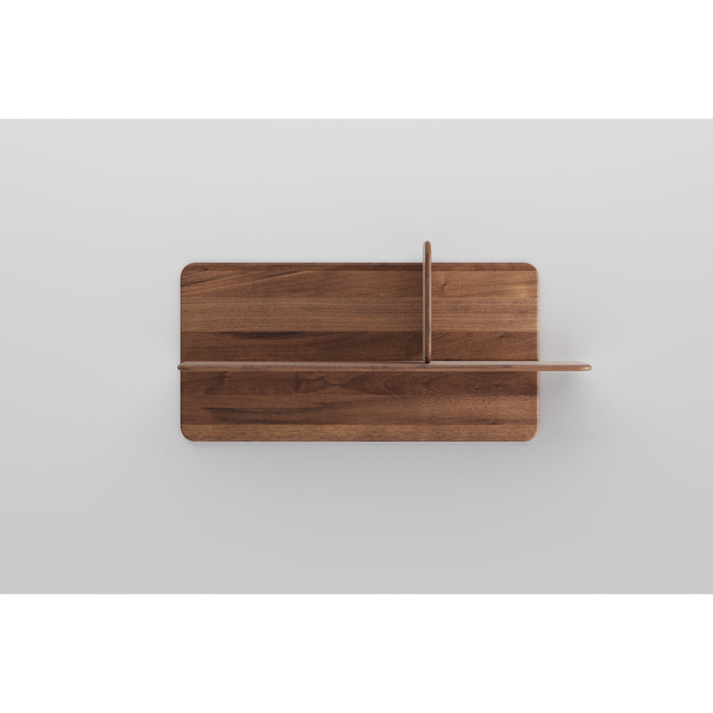 Part of the exclusive Artisan collection, the Soft Wall Modules feature elegant designs that create a cross shape. Made from organic materials, their rich brown tones and visible grain patterns stand out beautifully against the light gray surface.