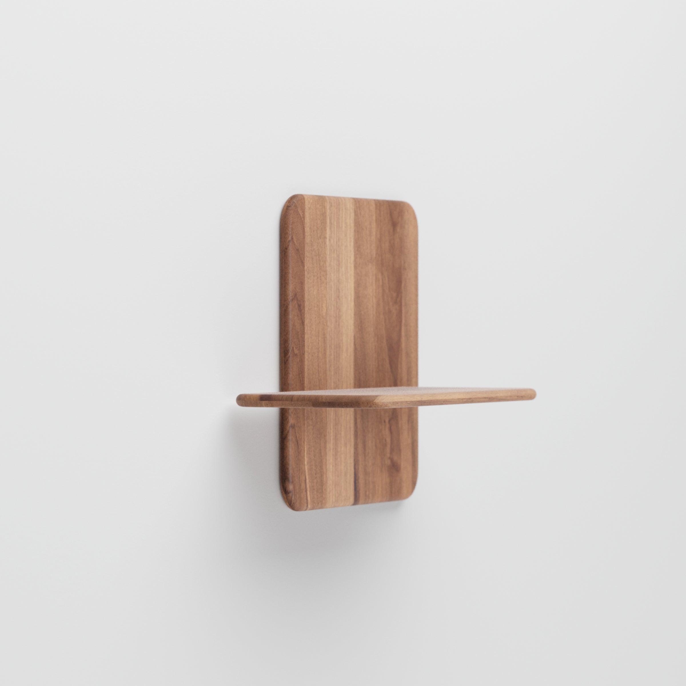 The Artisan Soft Wall Modules seamlessly mount on a white wall, highlighting their minimalist design. Crafted from light brown wood, they showcase natural grain with simple rectangular elegance. The back panel and platform join smoothly for a clean, modern look inspired by nature.