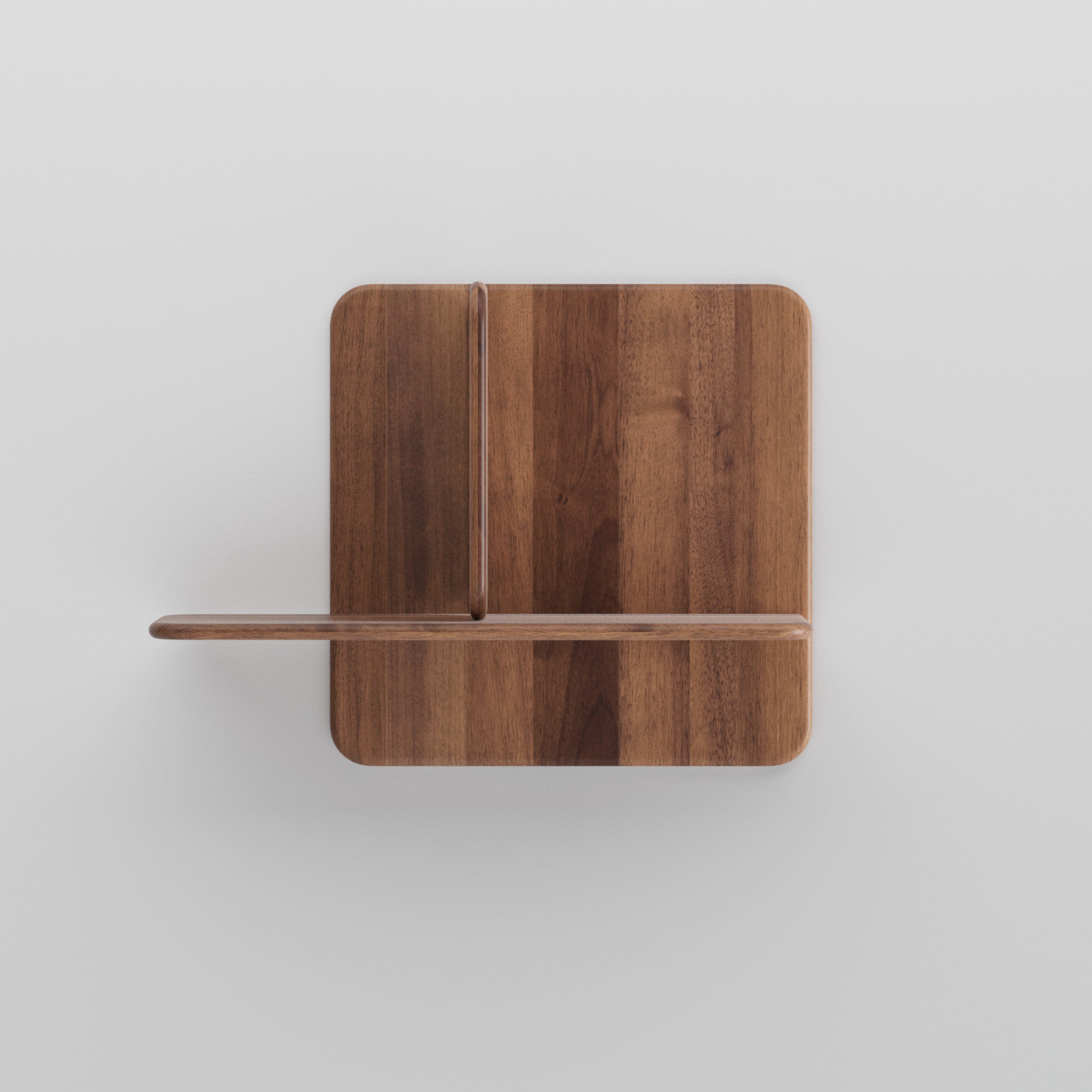 The Artisan Soft Wall Modules, minimalist wooden shelves, are elegantly mounted on a white wall. Their simple rectangular design features one horizontal and one vertical partition, showcasing a natural finish with visible grain patterns that highlight the organic materials.