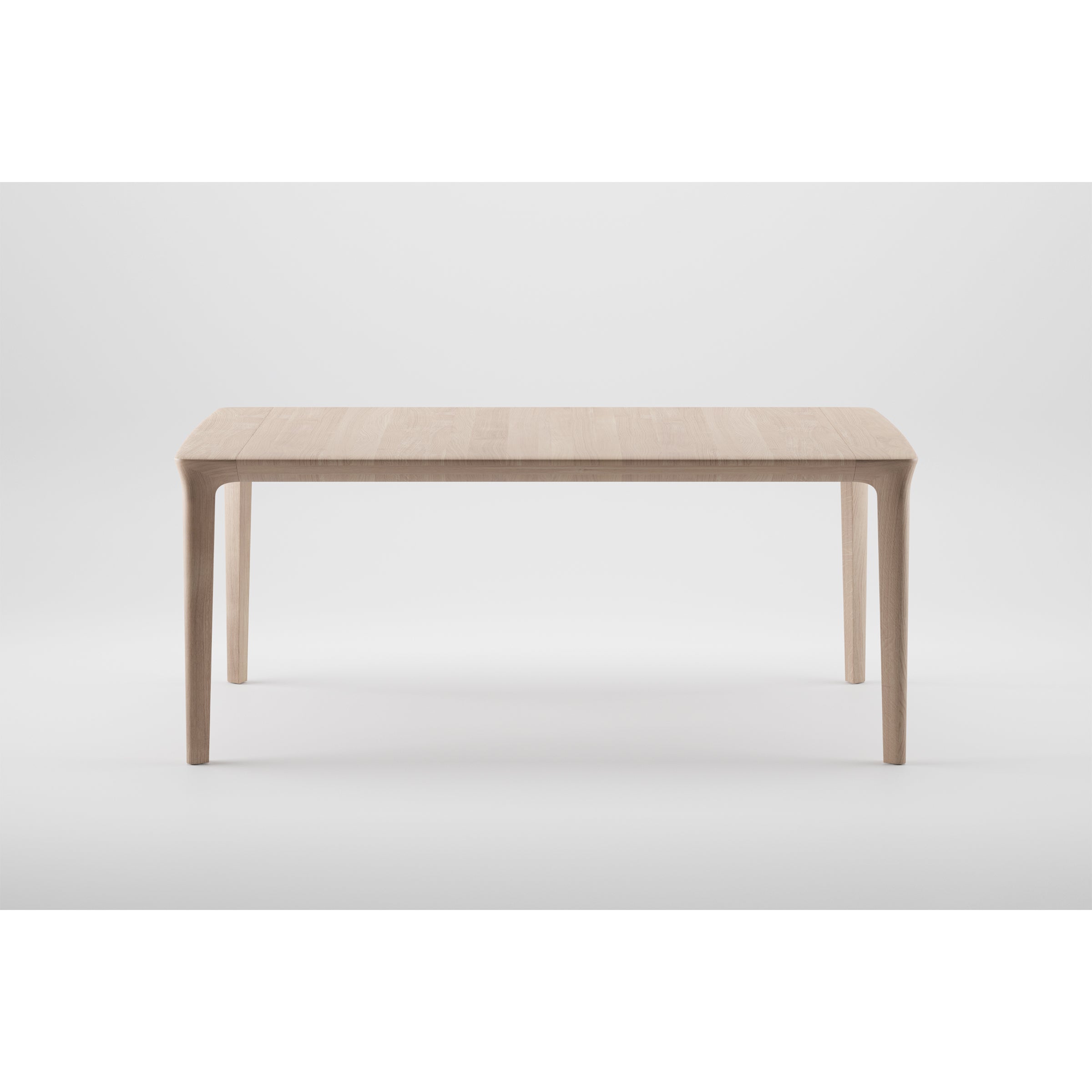 The TARA Table by Artisan is a minimalist solid wood piece with a rectangular top and four tapered legs. Set against a white background, it highlights its simple, elegant design and the organic beauty of eco-friendly materials.