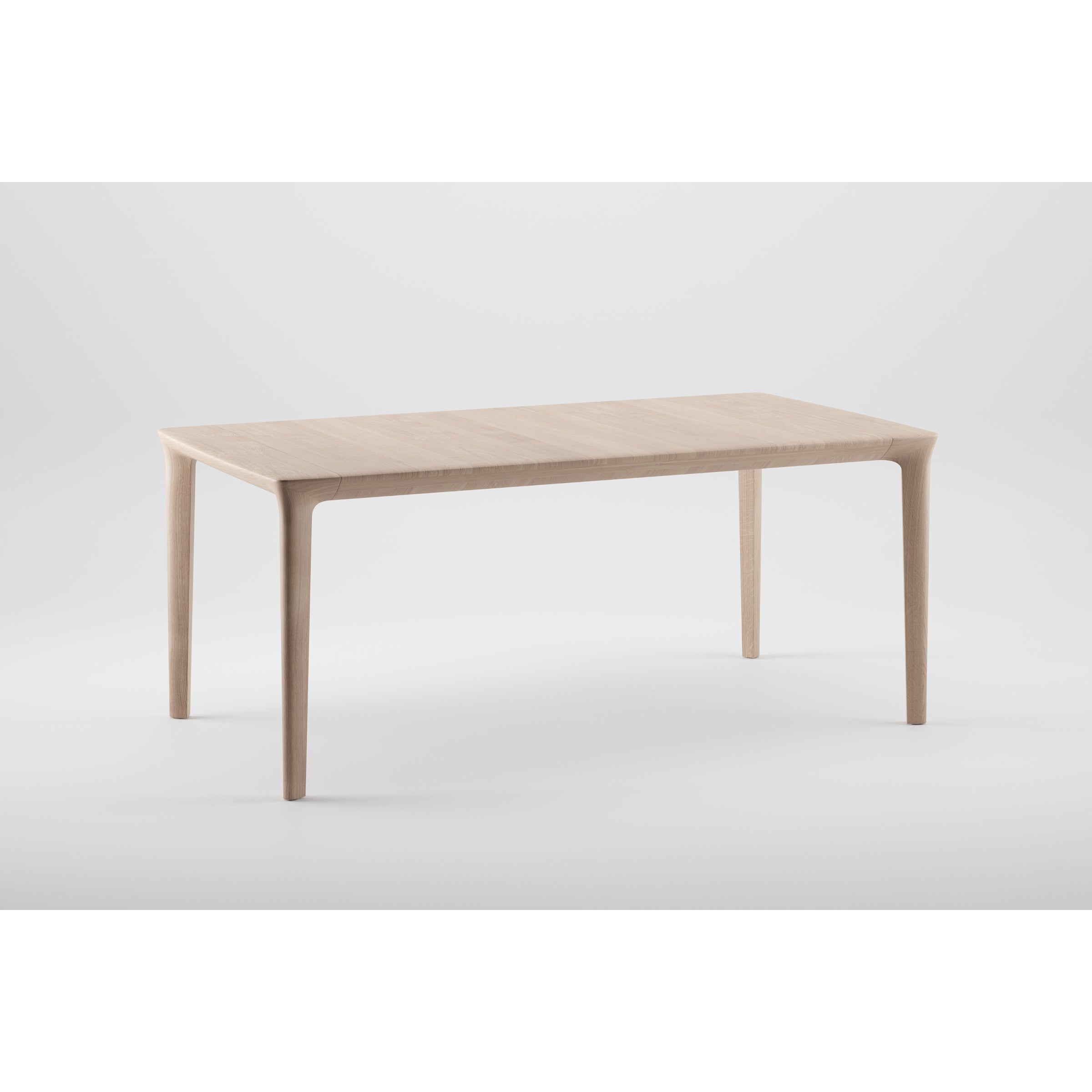The Artisan TARA Extendable Table showcases organic beauty with its rectangular surface and slender legs, crafted from solid wood, set against a plain white background.
