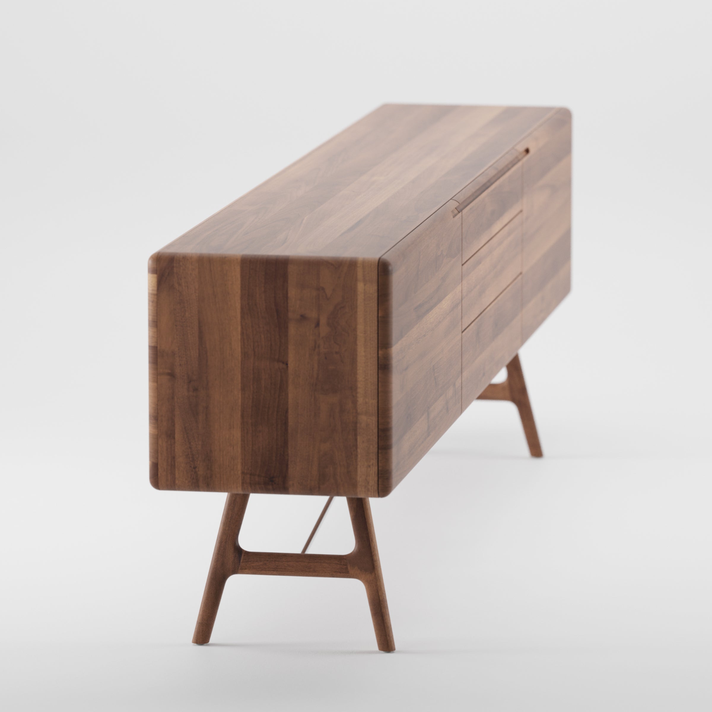 The TESA Sideboard by Artisan is a modern piece crafted from solid dark wood, featuring a polished surface, rectangular shape, and clean lines. It stands on angled, tapered legs and showcases the natural wood grain with an eco-friendly oil finish.