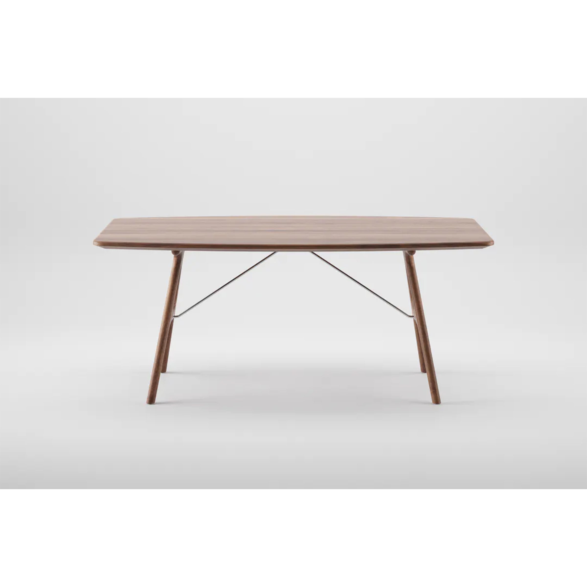 The Artisan TESA Table features a minimalist rectangular solid wood top with angled legs, enhanced by natural oils. Supported by metal crossbars beneath, its elegant design stands out against a plain white background.