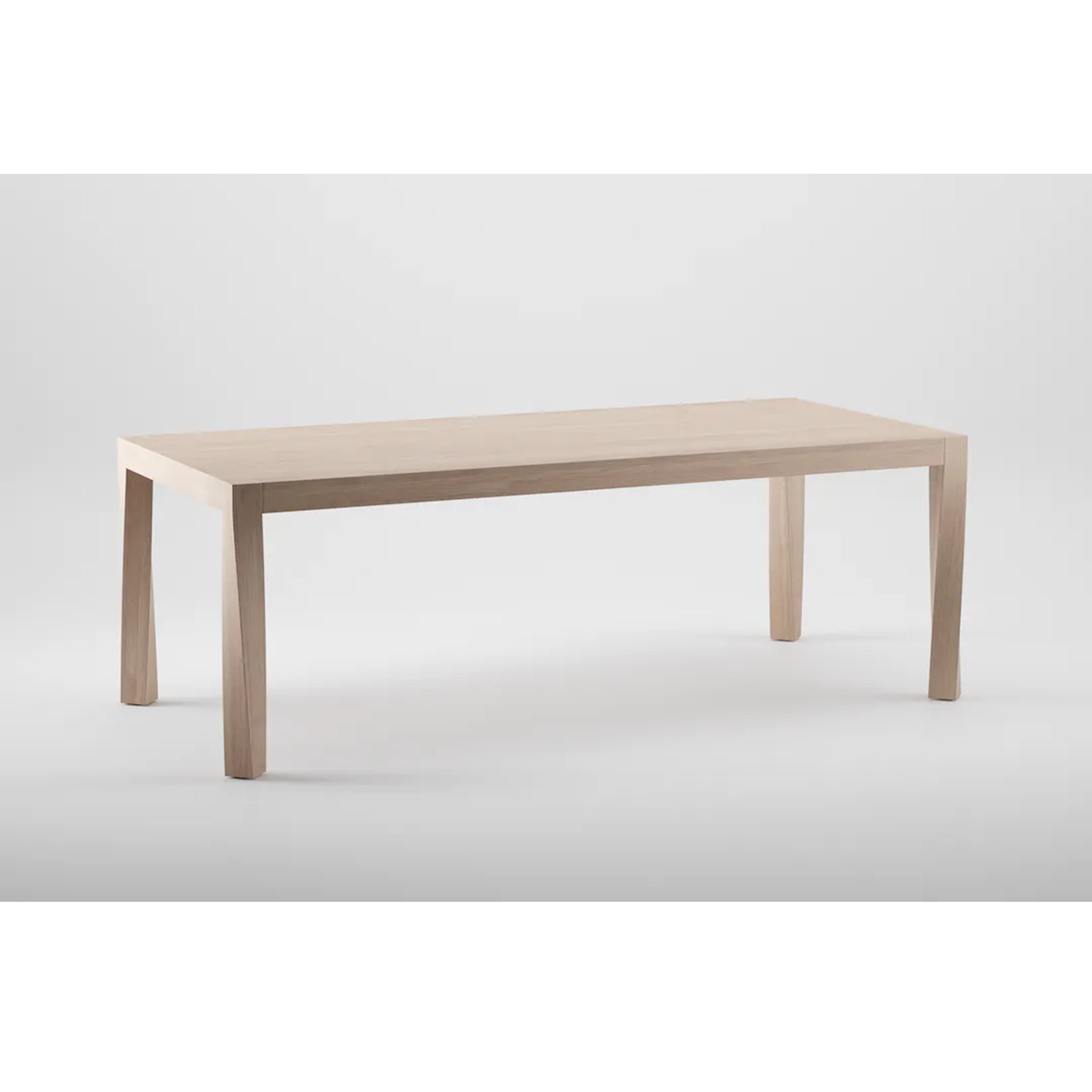 The TOR Table by Artisan is a minimalist dining table crafted from solid wood with a light brown finish. It features a rectangular design with simple, straight lines and four sturdy legs, set against a white background to emphasize its sleek design and organic beauty.
