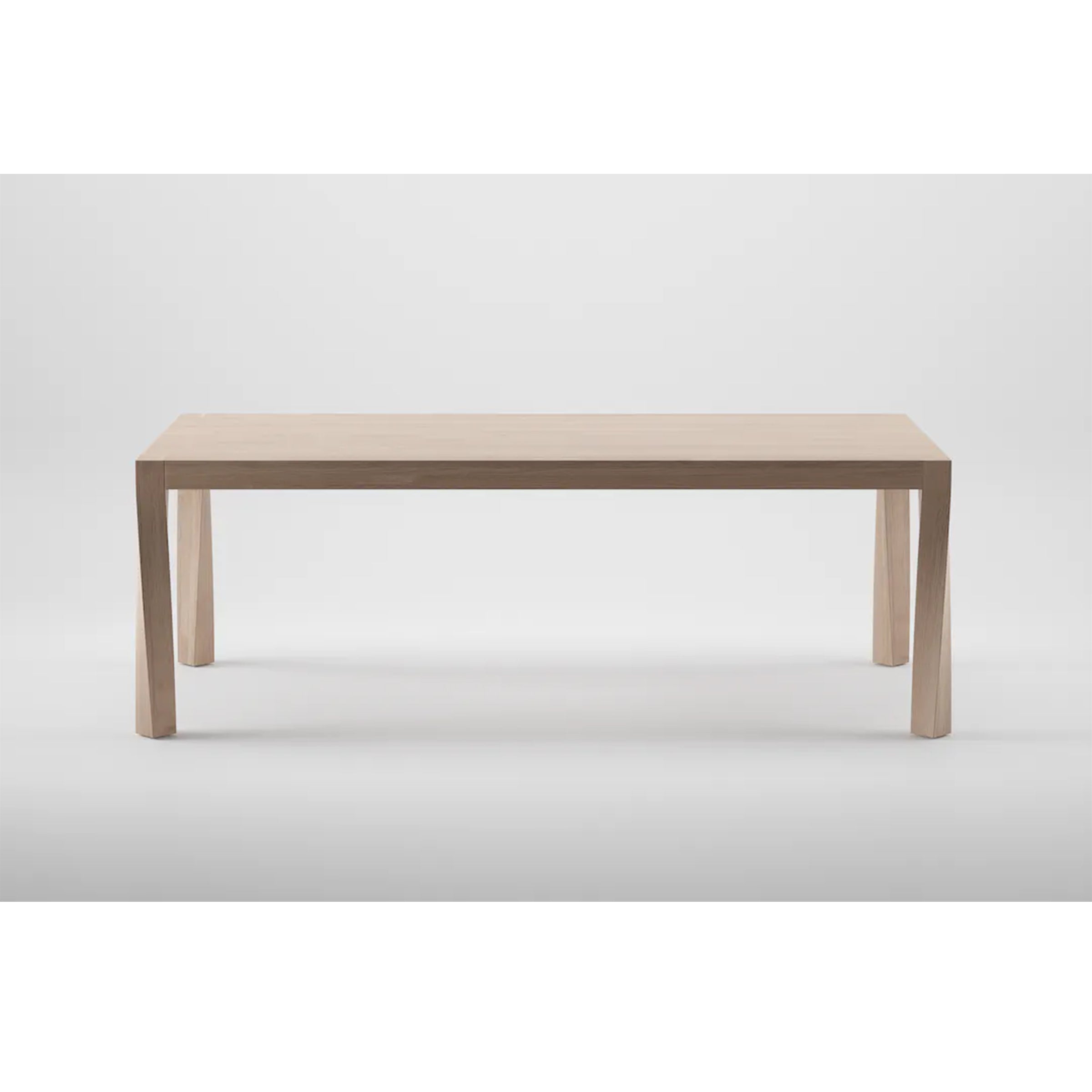 The Artisan TOR Table is a minimalist wooden piece, crafted from solid wood with a light natural finish. With its rectangular top and four straight legs, it accentuates an organic beauty and simple modern design against a plain white background.
