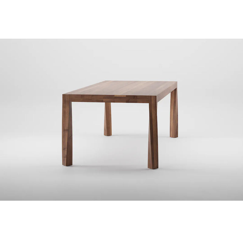 The Artisan TOR Table, a minimalist piece made from solid wood, is centered against a plain white background. Its rectangular top and four straight, slightly angled legs showcase a smooth finish that highlights the organic beauty of its visible grain patterns.