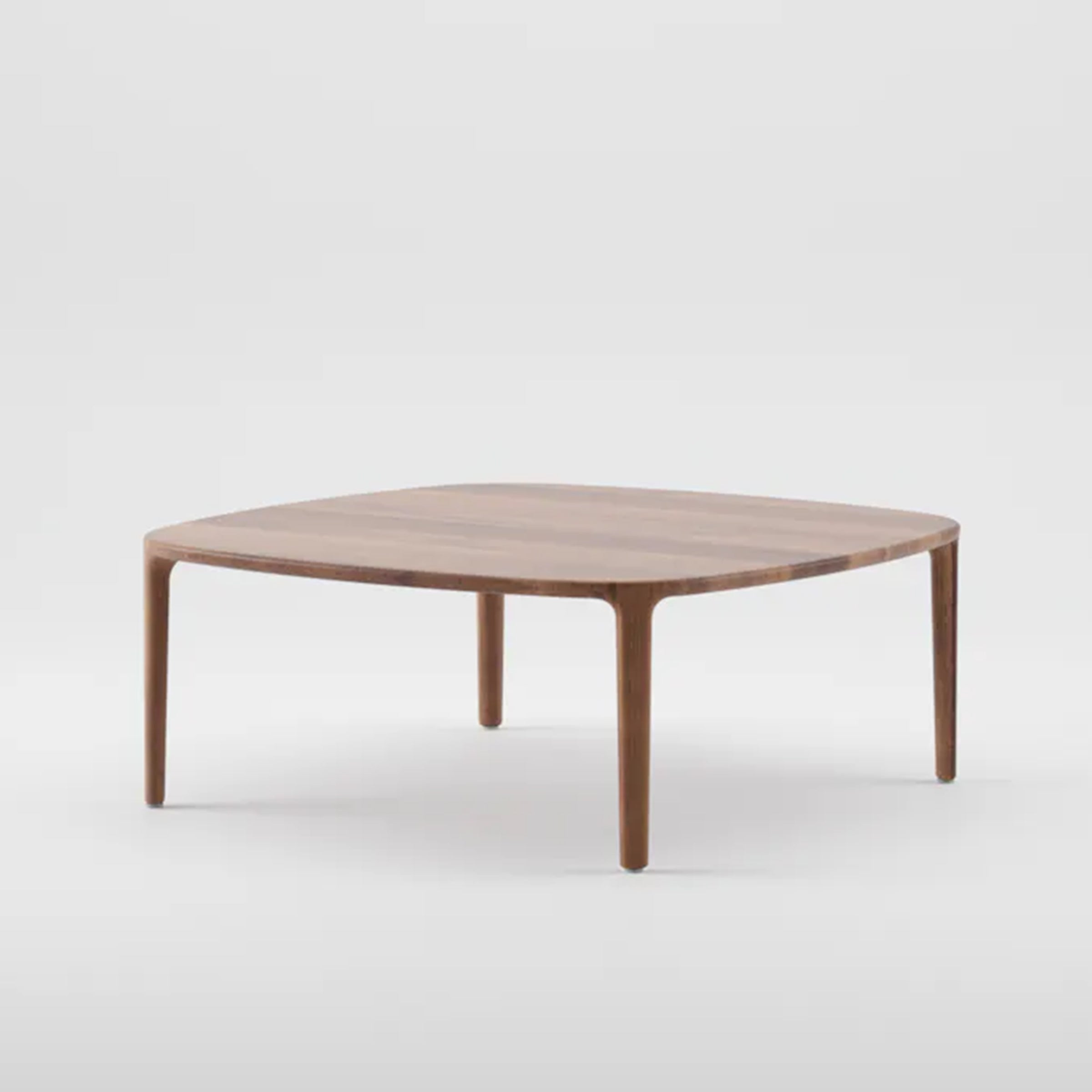 The WU Coffee Table by Artisan is a square design made from solid wood, featuring rounded edges and sleek, tapered legs, showcased on a plain white background.
