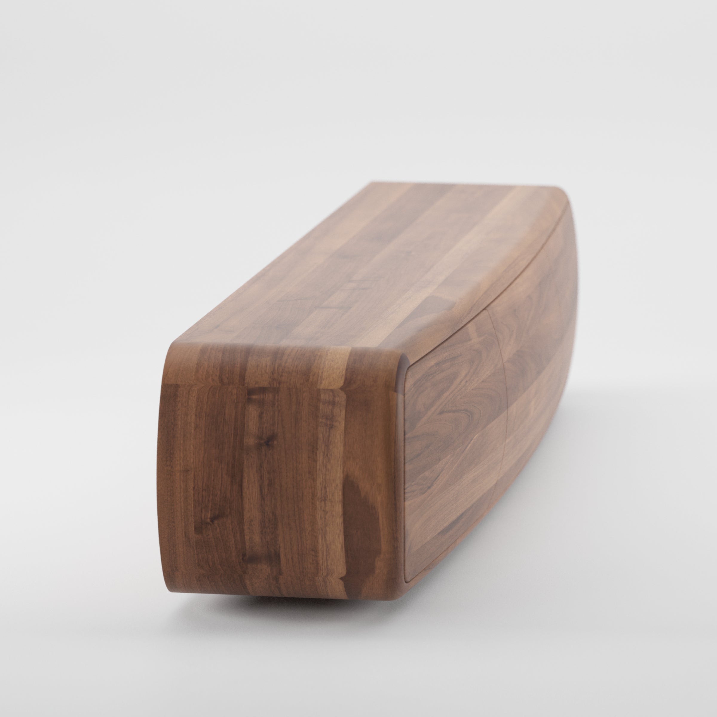 The WU Sideboard by Artisan features a polished, sleek curved design crafted from solid wood. Its rich brown hue and organic wood texture contrast beautifully against a plain white background, highlighting its environmentally-friendly materials.