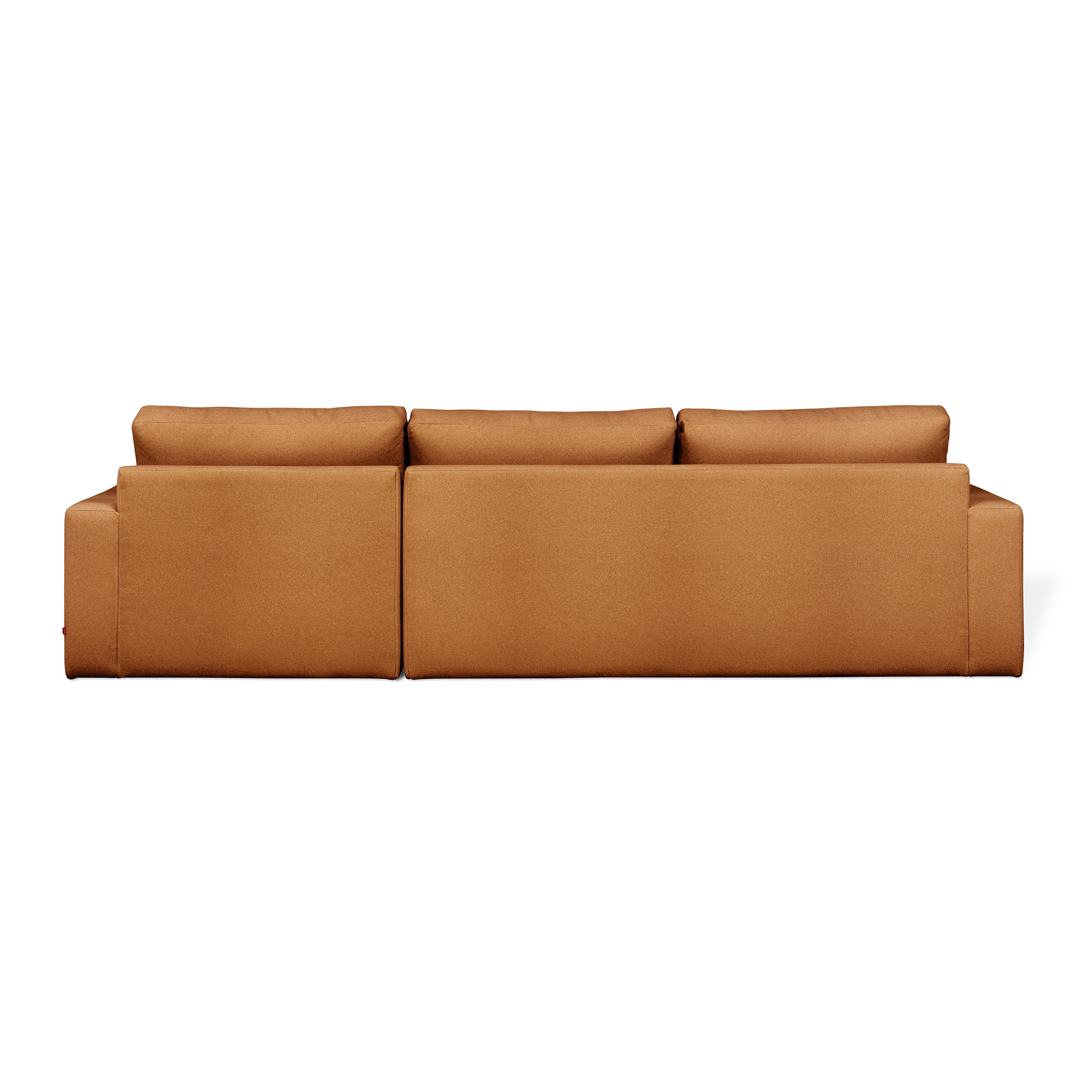 Back view of the Ashdale Right-Facing Sectional by Gus Modern, a modern three-seat sofa with a sturdy hardwood frame and light brown upholstery, featuring clean lines and rectangular cushions against a white background.