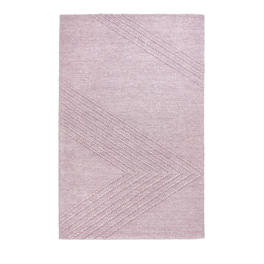 The Avro Rug by Gus Modern features a rectangular, light pink minimalist design with a subtle chevron pattern of diagonal lines on a soft, modern background for a clean and simple look.