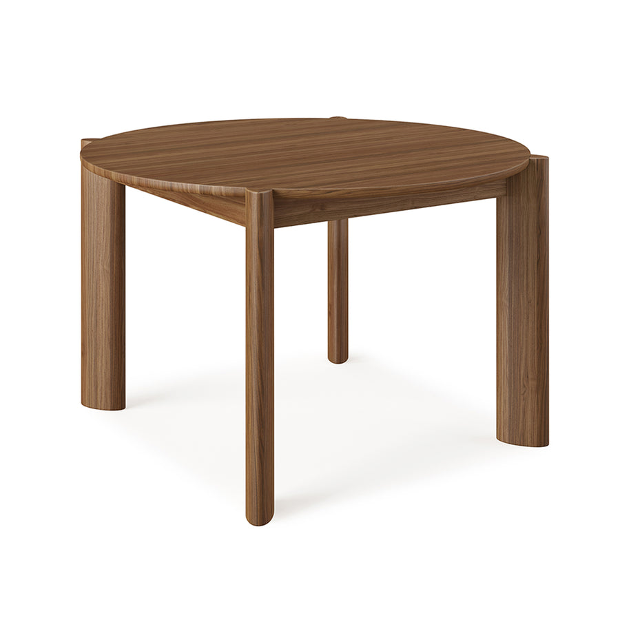The Gus Modern Bancroft Dining Table Round features a smooth dark brown solid wood top and four thick cylindrical legs, shown here on a white background.