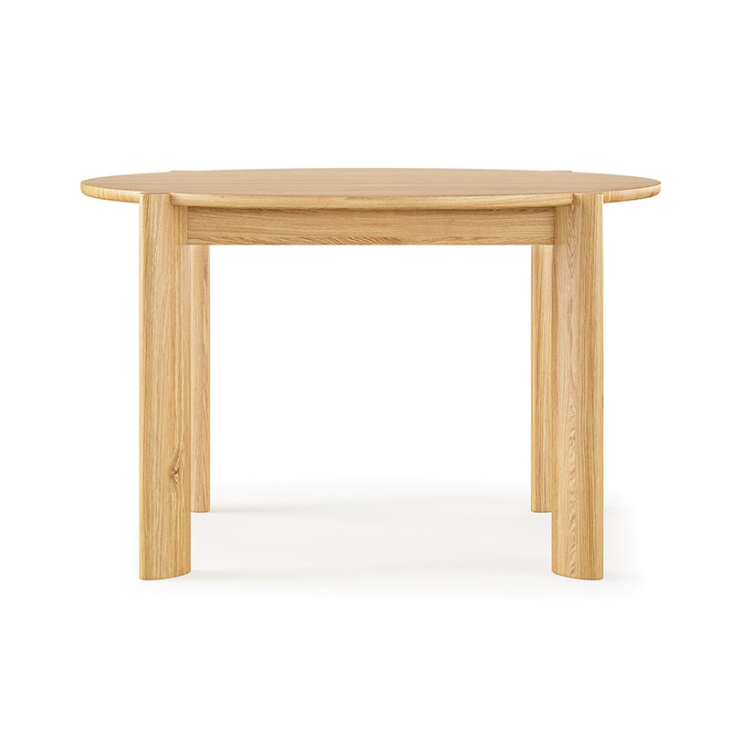 The Bancroft Dining Table Round by Gus Modern is a solid wood table with a light natural finish, four sturdy legs, and a smooth tabletop, shown against a plain white background.