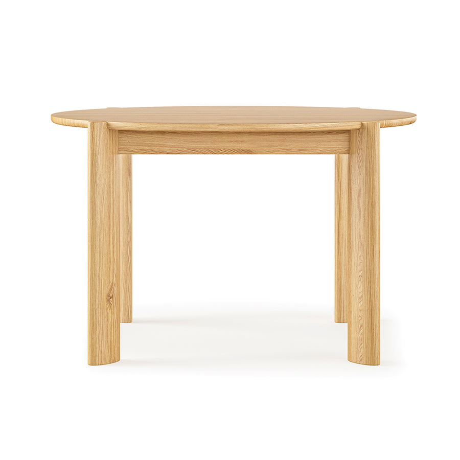 The Bancroft Dining Table Round by Gus Modern is a solid wood table with a light natural finish, four sturdy legs, and a smooth tabletop, shown against a plain white background.