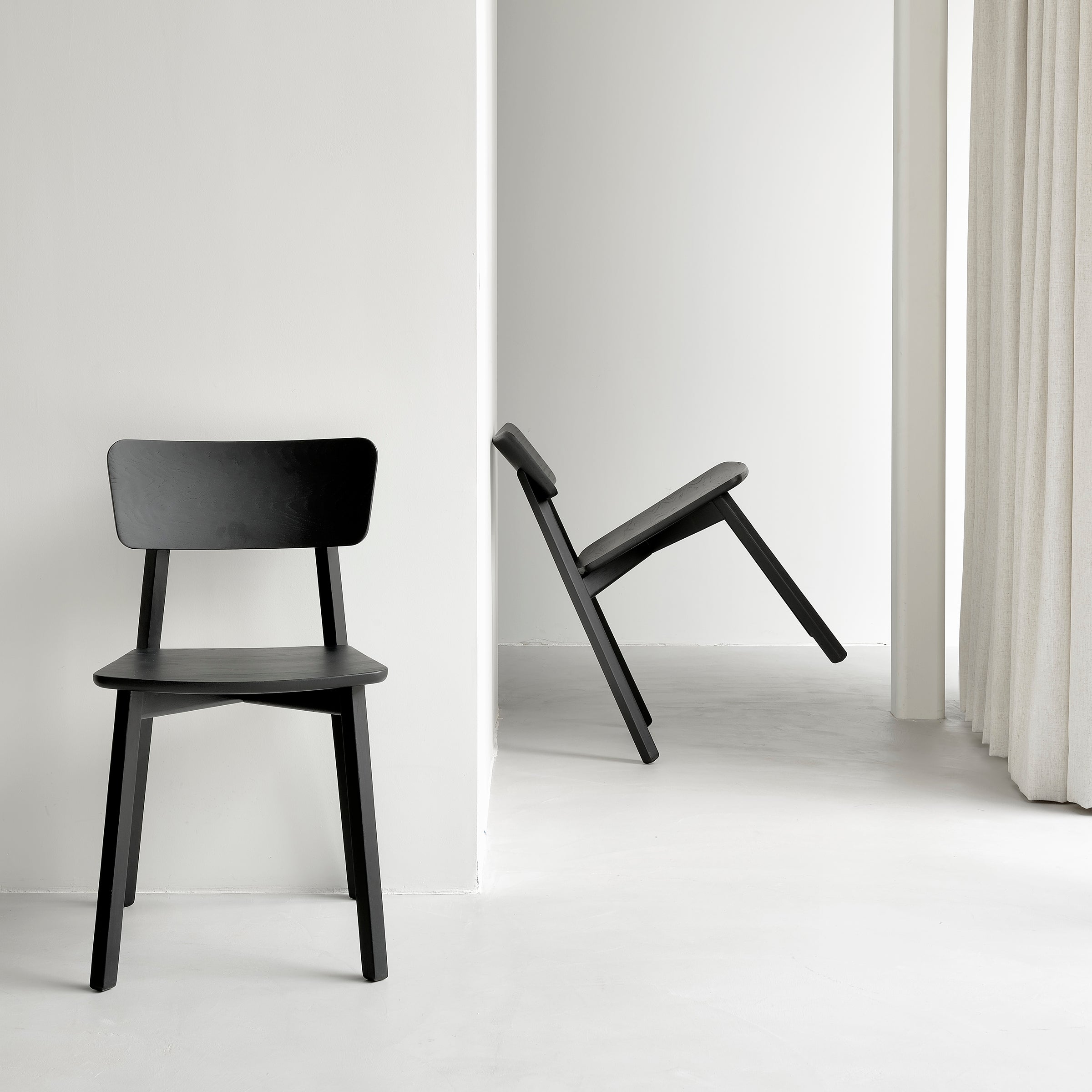 Casale Dining Chair in black varnished oak with straight lines and a smooth, delicate shape by Studio Kaschkasch.