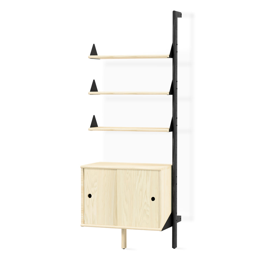 The Gus Modern Branch Storage Unit Add-On is a minimalist wooden wall shelving unit with three open shelves and a two-door cabinet, featuring light wood elements and a black contrasting vertical frame for modular organization.