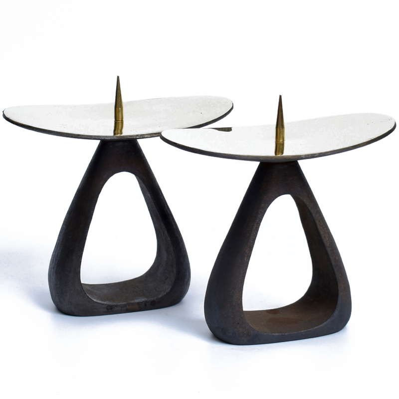 Candlestick #3470 by Werkstätte Carl Auböck features two dark, triangular open-base candle holders. Each has a curved, reflective silver platform and a central gold spike for securing candles, embodying modern and abstract design elements reminiscent of Carl Auböcks style.