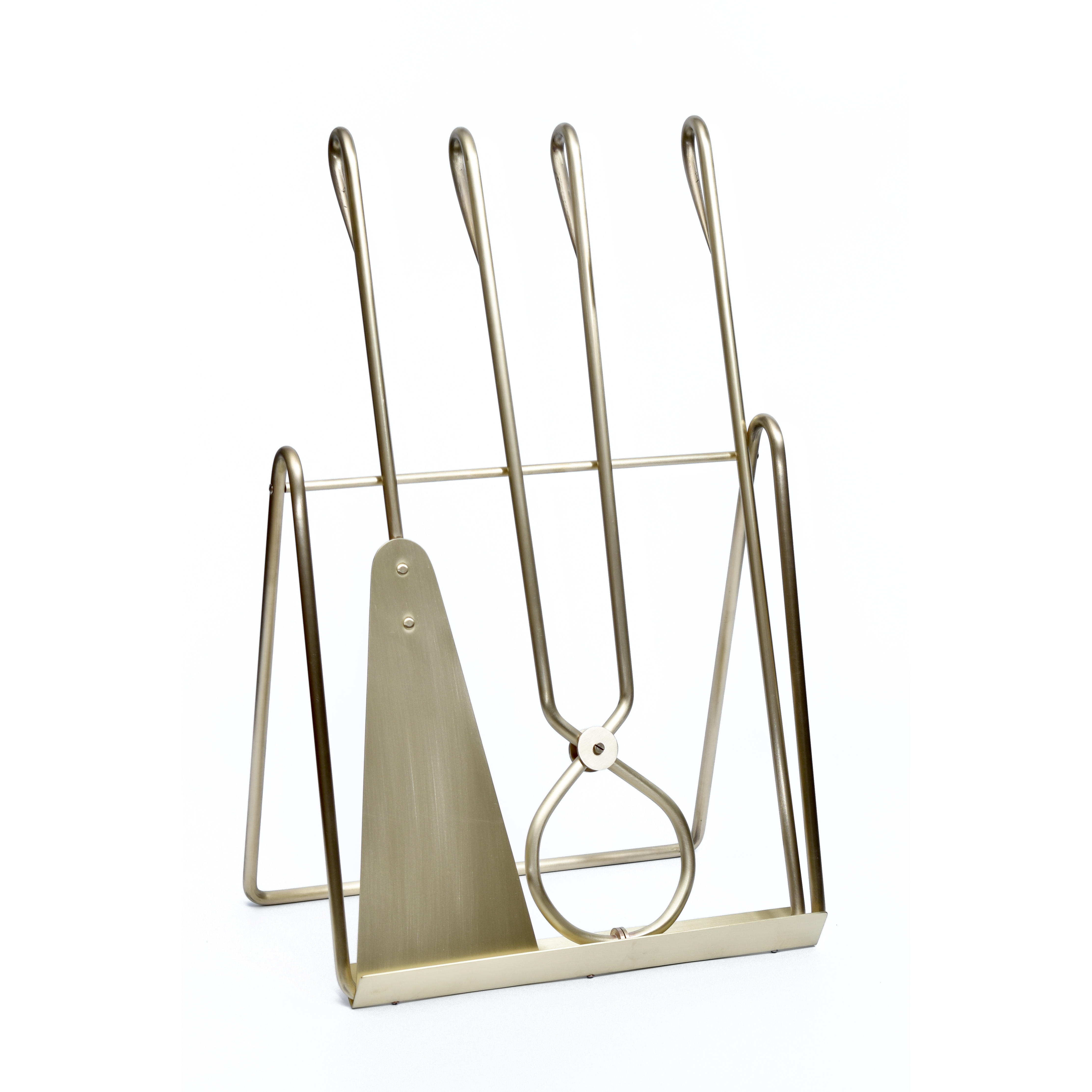 The Werkstätte Carl Auböck Fireplace set #4180 features a brass finish and includes a shovel, tongs, and poker on a matching stand. Its sleek, modern design with looped handles is displayed against a plain white background.