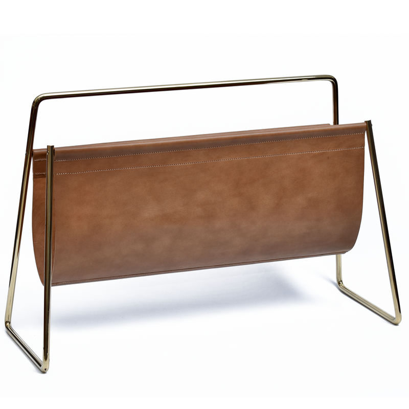 Magazine Rack #4488 by Werkstätte Carl Auböck features a brown leather sling and gold metal frame, standing on a white background. Its clean lines and minimalist style echo the elegance and functionality of Carl Auböck design.