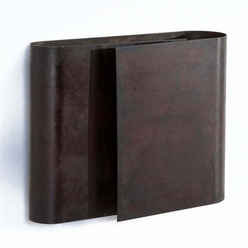 This wall-mounted dark brown metal magazine holder from Werkstätte Carl Auböck, reminiscent of a Carl Auböck design, features an elegant oval shape with an open front, perfect for adding a touch of Viennese townhouse charm to your space.