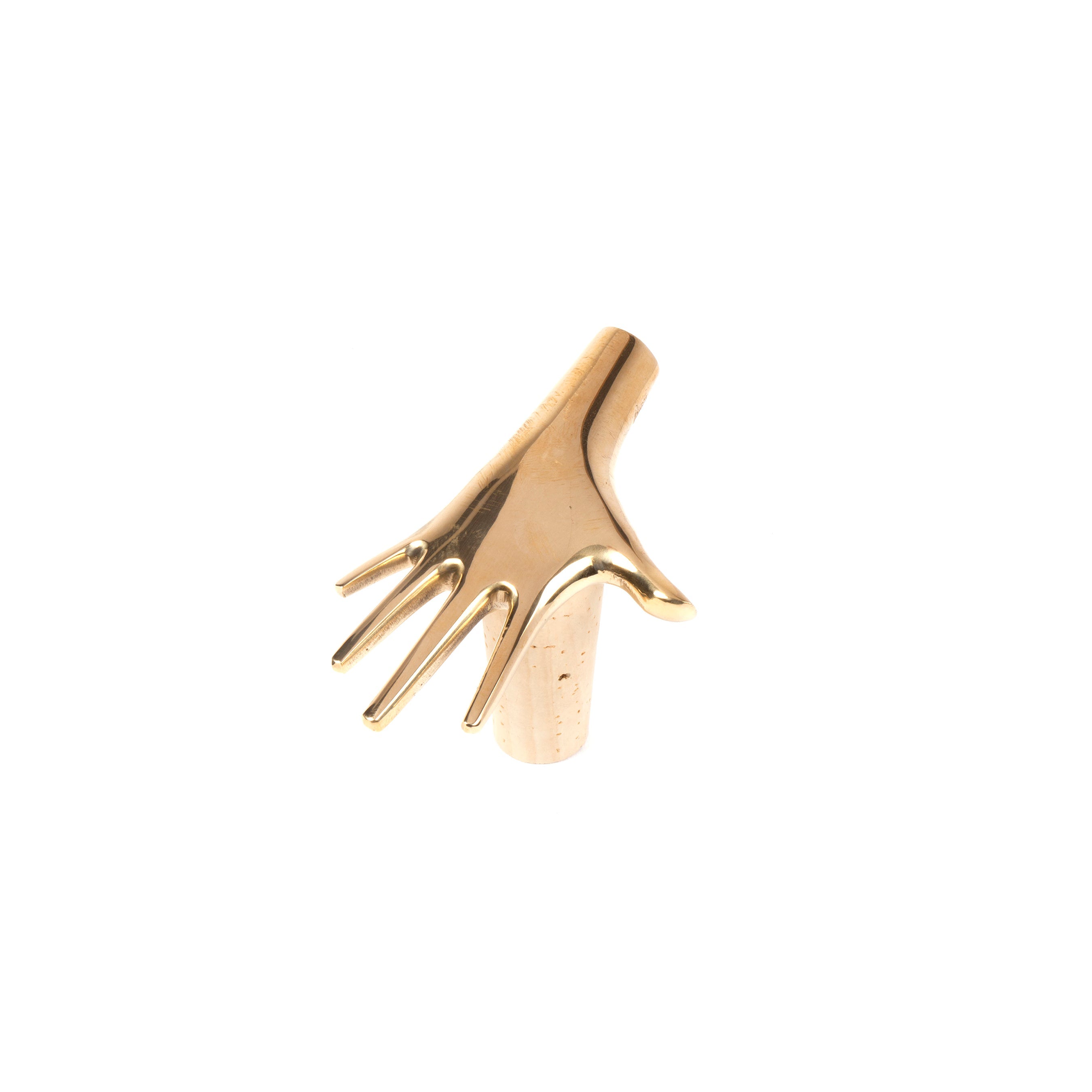 The Corkstopper Palm #4220 by Werkstätte Carl Auböck is a gold, hand-shaped sculptural object with elongated fingers and a streamlined design, evoking the elegance of a Viennese townhouse against a plain white background.