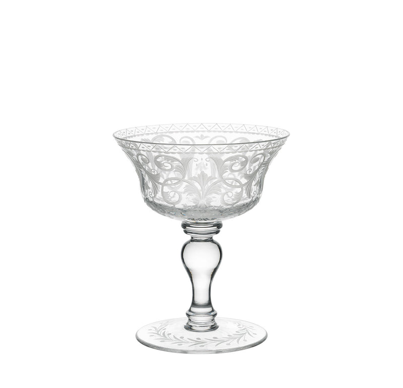 The Lobmeyr Drinking Set No. 231 - Barock features a clear, intricately etched coupe glass with elegant floral and geometric patterns, reminiscent of Viennese Baroque style. The mouth-blown lead-free crystal has a wide bowl and a short, thick stem with a round base.