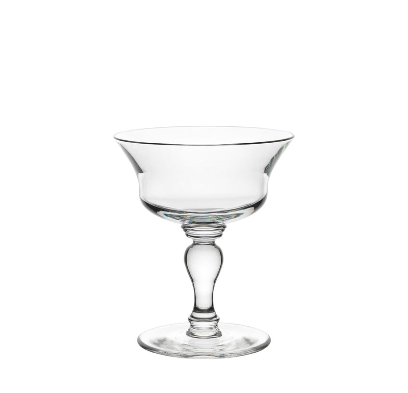 The Lobmeyr Drinking Set No. 231 - Barock, a sophisticated clear glass coupe with a wide bowl and elegant stem on a circular base, shines against a white background, reflecting its polished, mouth-blown lead-free crystal craftsmanship.