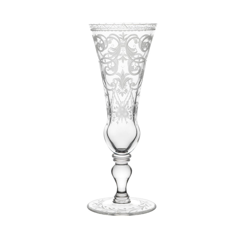 The Lobmeyr Drinking Set No. 231 - Barock features mouth-blown, lead-free crystal champagne flutes with ornate engraved patterns adorning both the bowl and stem, set on a white background.