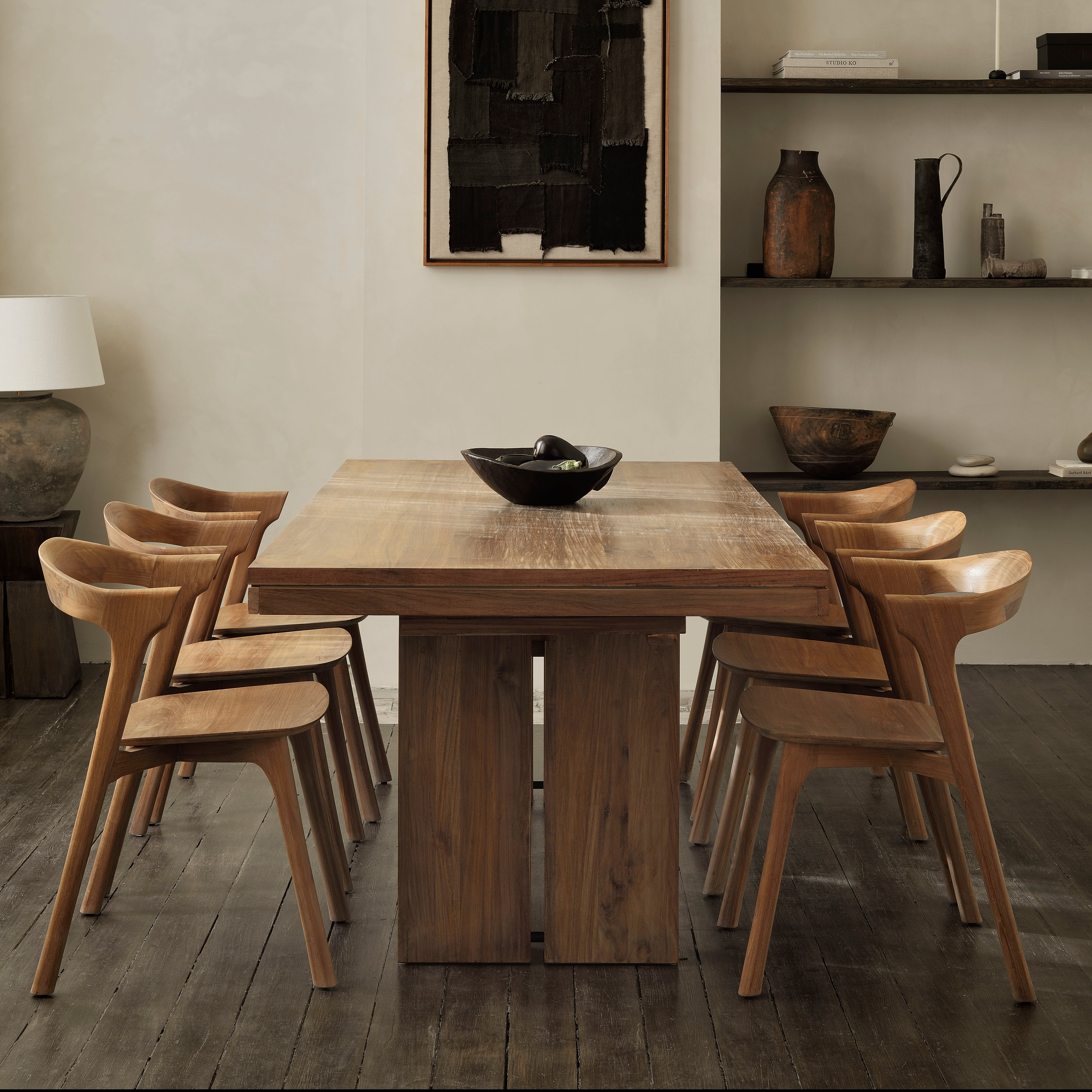 Double Extendable Dining Table in teak wood with modern solid design and six matching wooden chairs in a stylish dining room.