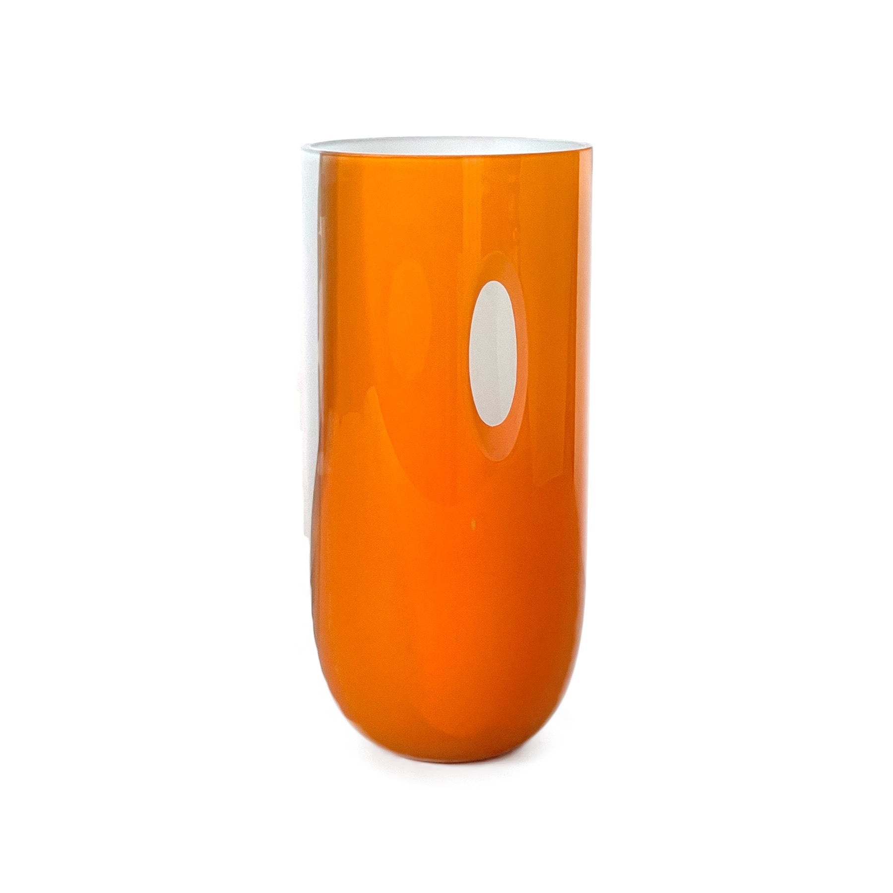 This orange glass tumbler by Ursula Futura resembles a mini ECLIPSE Vase, boasting a smooth, cylindrical form with a reflective white oval accent. This elegant design piece stands out against a white background, highlighting its mouth-blown glass craftsmanship.