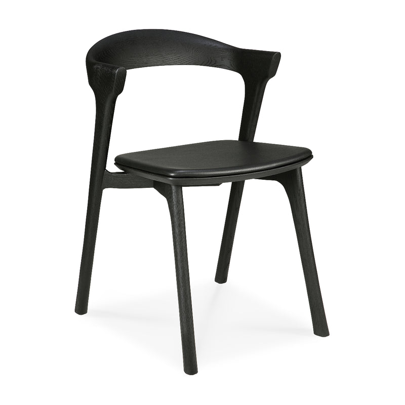 Bok Dining Chair Upholstered in black varnished oak with ergonomic design and modern sleek style for dining rooms.