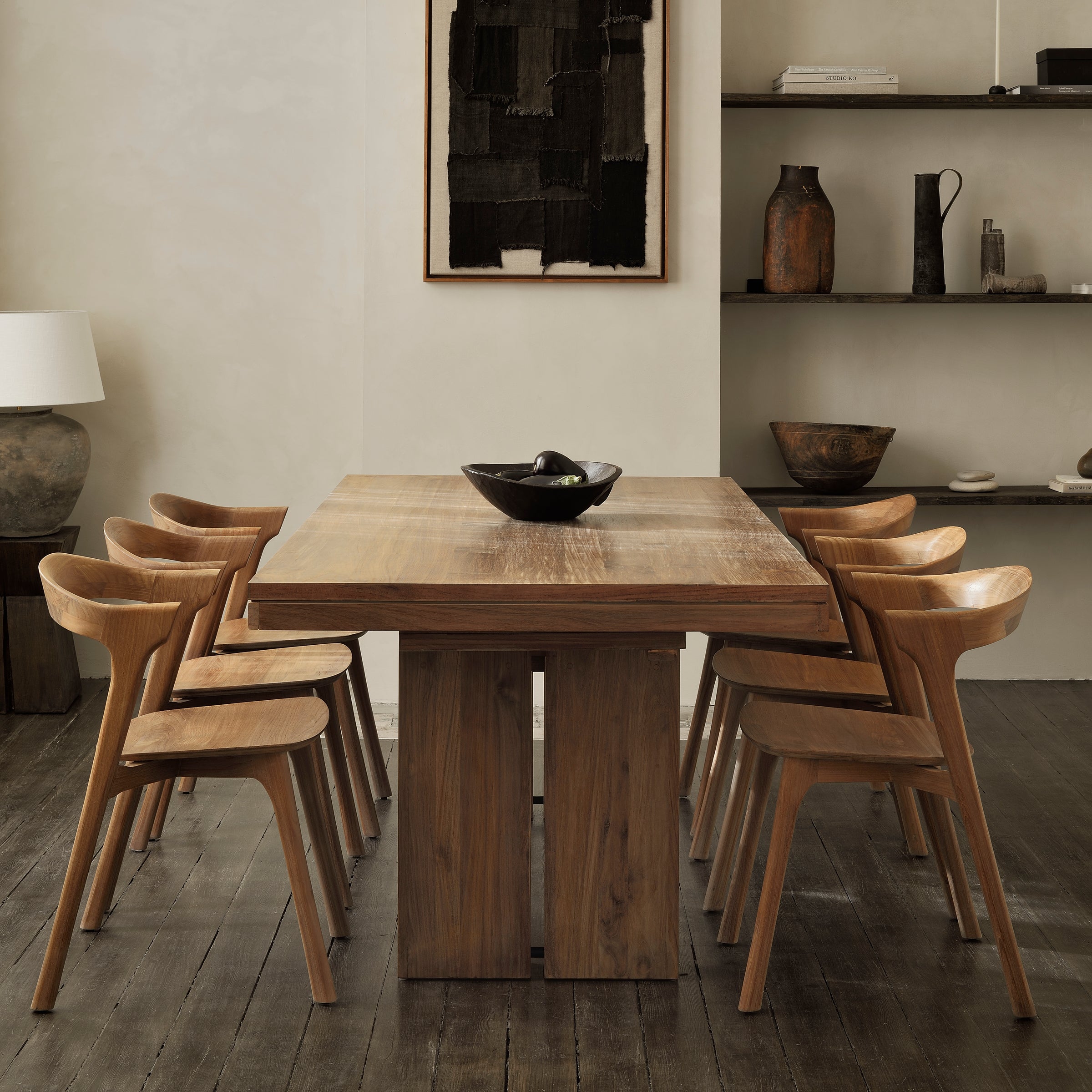 Bok Dining Chair set around a wooden table in a modern dining room with minimalist decor.