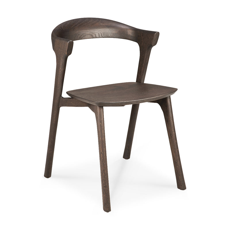Bok Dining Chair made of varnished dark oak wood with ergonomic curved backrest and sleek modern design.