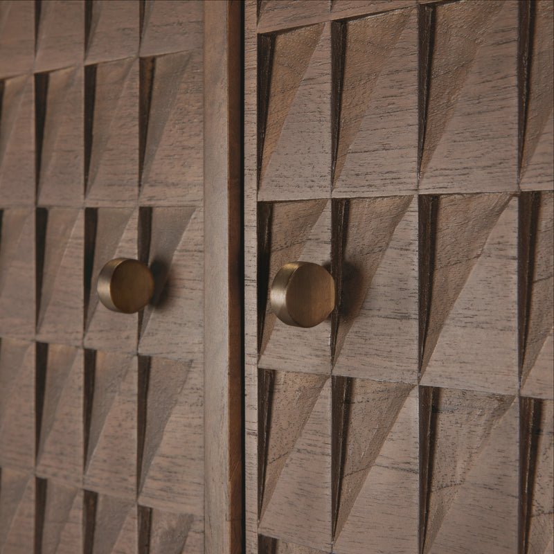 Close-up of hand-carved teak wood panels with brass handles on the Sono Cupboard by Ethnicraft.