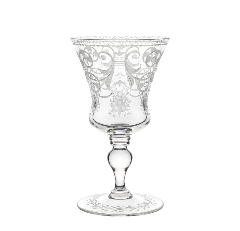 The Lobmeyr Drinking Set No. 231 - Barock features elegant, clear goblets made of mouth-blown lead-free crystal, adorned with engraved floral patterns. The decorative stem and wide base reflect Viennese Baroque design, complemented by swirling motifs for a delicate touch.