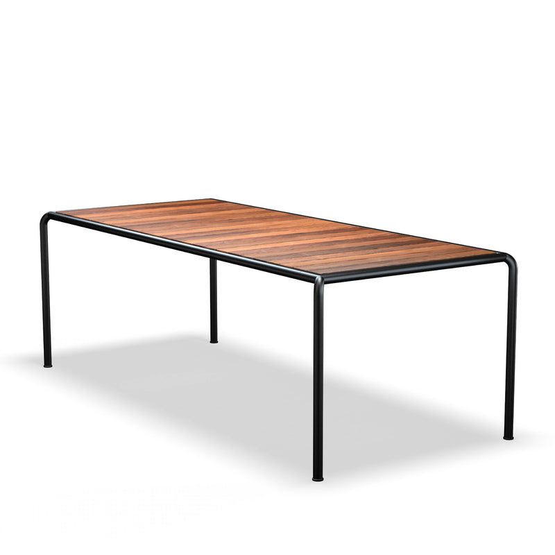 The Avanti Table by Houe boasts a rectangular wood top with sleek black metal legs, creating subtle contrast on a white backdrop. Its modular design supports easy customization through various extension sets.