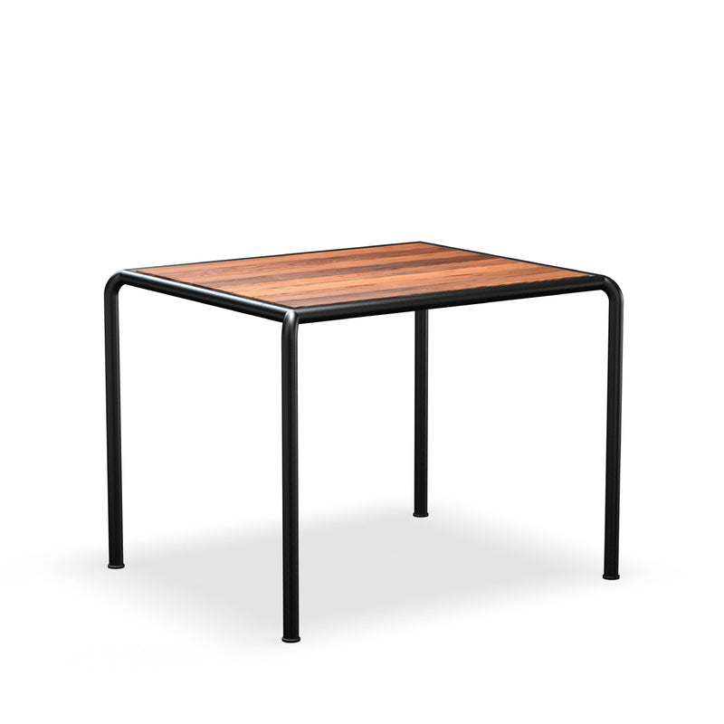 The Avanti Table by Houe showcases a minimalist square design with a wooden top and four black metal legs, offering elegance against any white background. Its modular structure allows easy integration with extensions, ensuring versatility for any space.