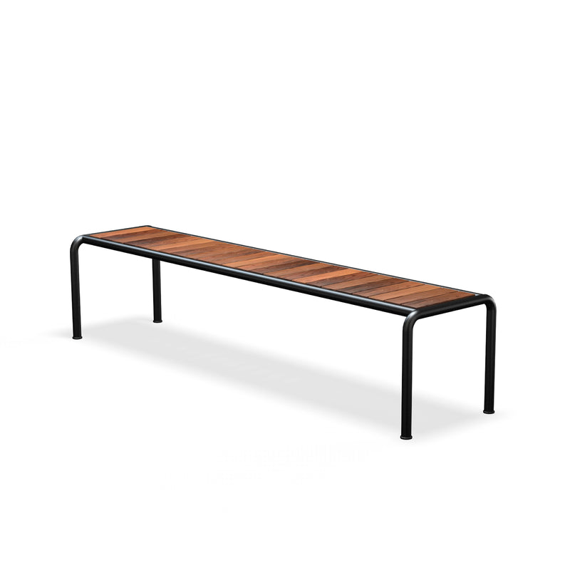 The Avanti Bench by Houe features a minimalistic design with a rectangular seat made of wooden slats, supported by a sleek black metal frame and rounded legs. Its modern, functional, and ideal for both indoor and outdoor settings.