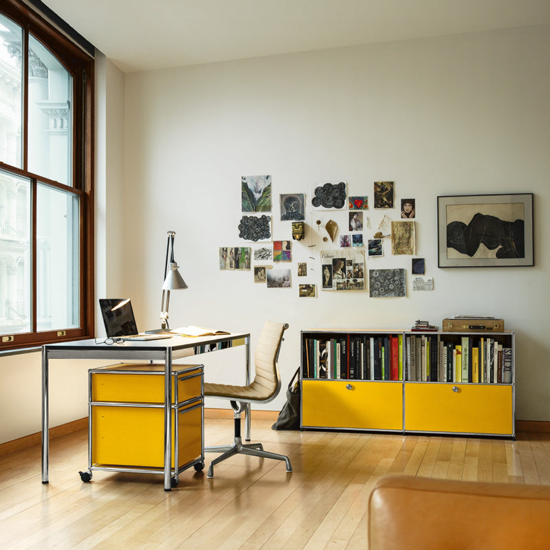 Haller Credenza C2A in steel blue with open top shelves and two lockable drop-down yellow doors in modern office setting.