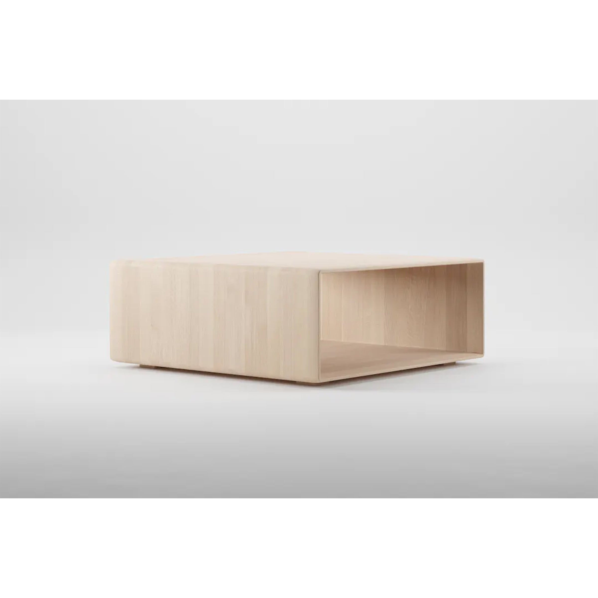 The INVITO Cube Coffee Table by Artisan is a minimalist wooden piece, crafted from eco-friendly solid wood with a light finish. It features a square shape and an open shelf underneath, elegantly showcased on a clean white background.