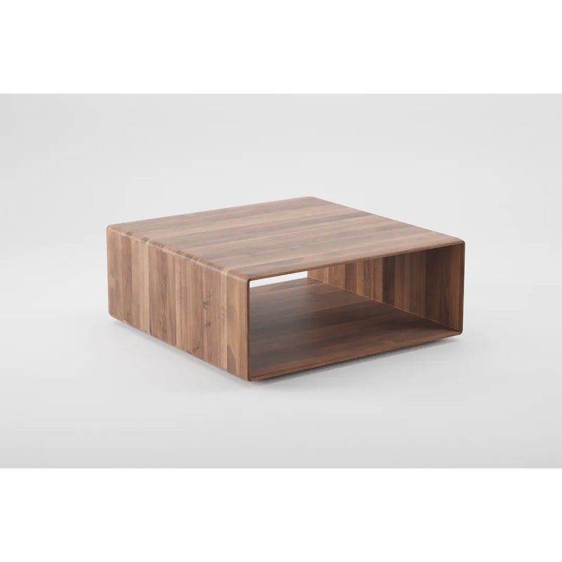 The INVITO Cube Coffee Table by Artisan is a square, solid wood piece finished with natural oils, enhancing its grain. It features an open shelf in its hollow center and is set against a plain white background, highlighting its environmentally-friendly materials.