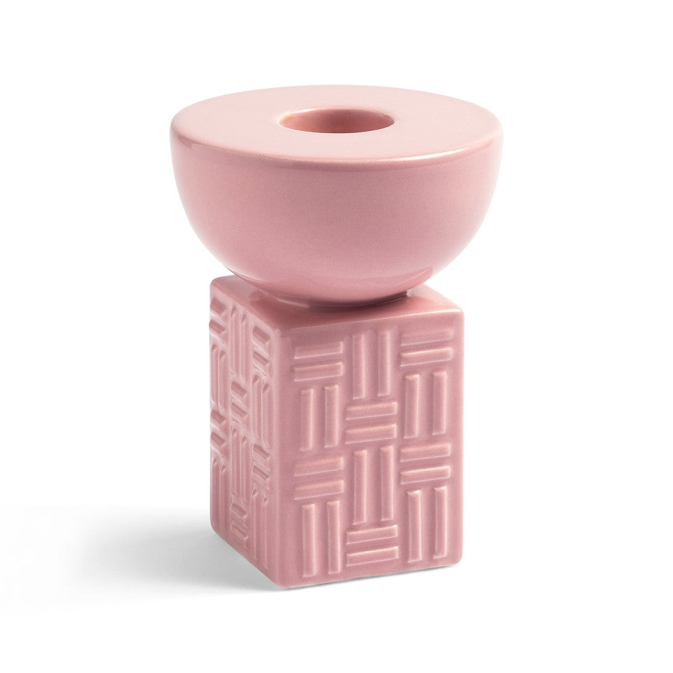 The &Klevering Candle Holder Stack Pink is a retro-style ceramic candlestick with a pink round top and square base featuring a geometric pattern, set against a white background.