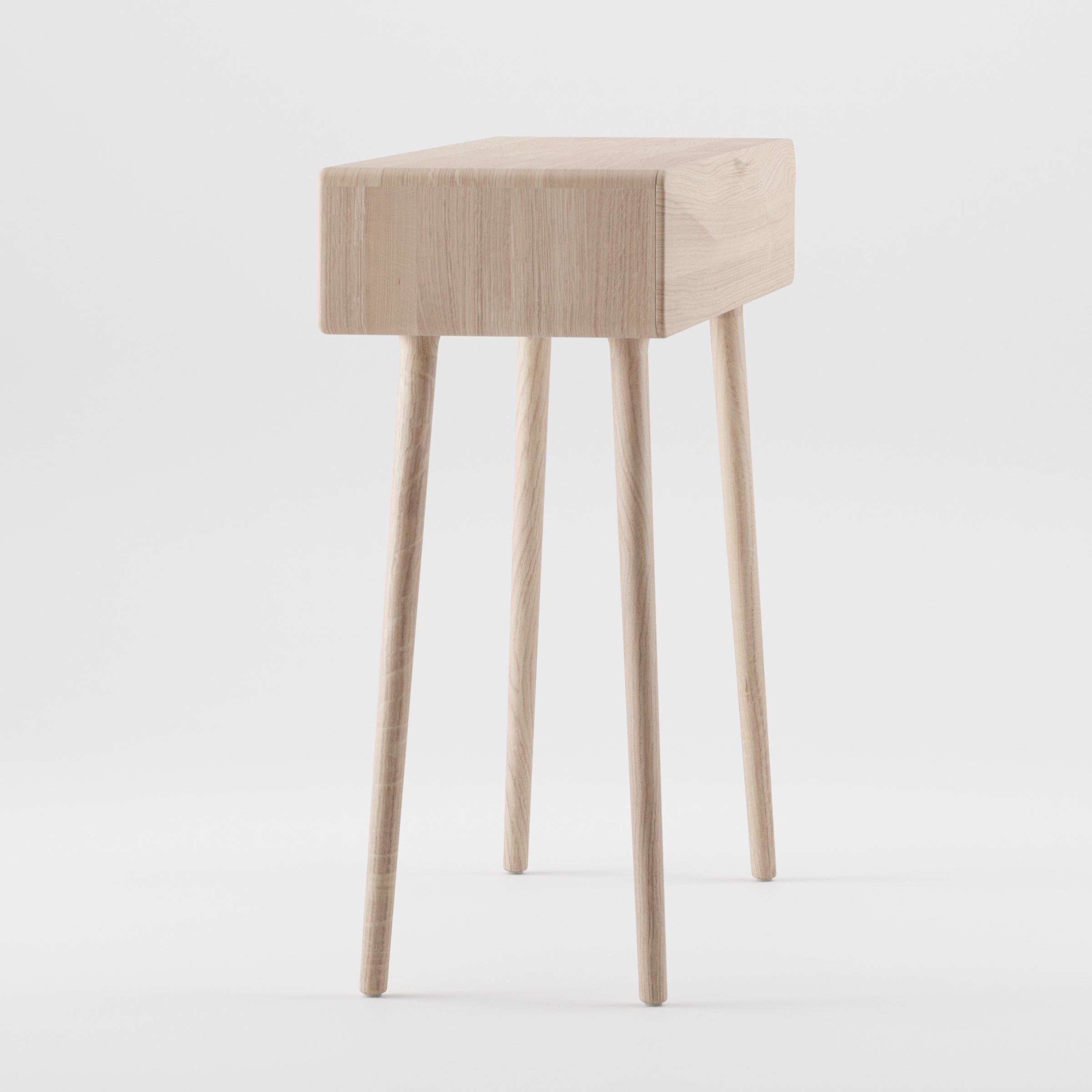 The LASTA Console table by Artisan boasts a minimalist design with a solid wood rectangular top and four slender legs. Natural oils enhance its sleek contemporary look, while the light-colored finish provides striking contrast against a plain white background.