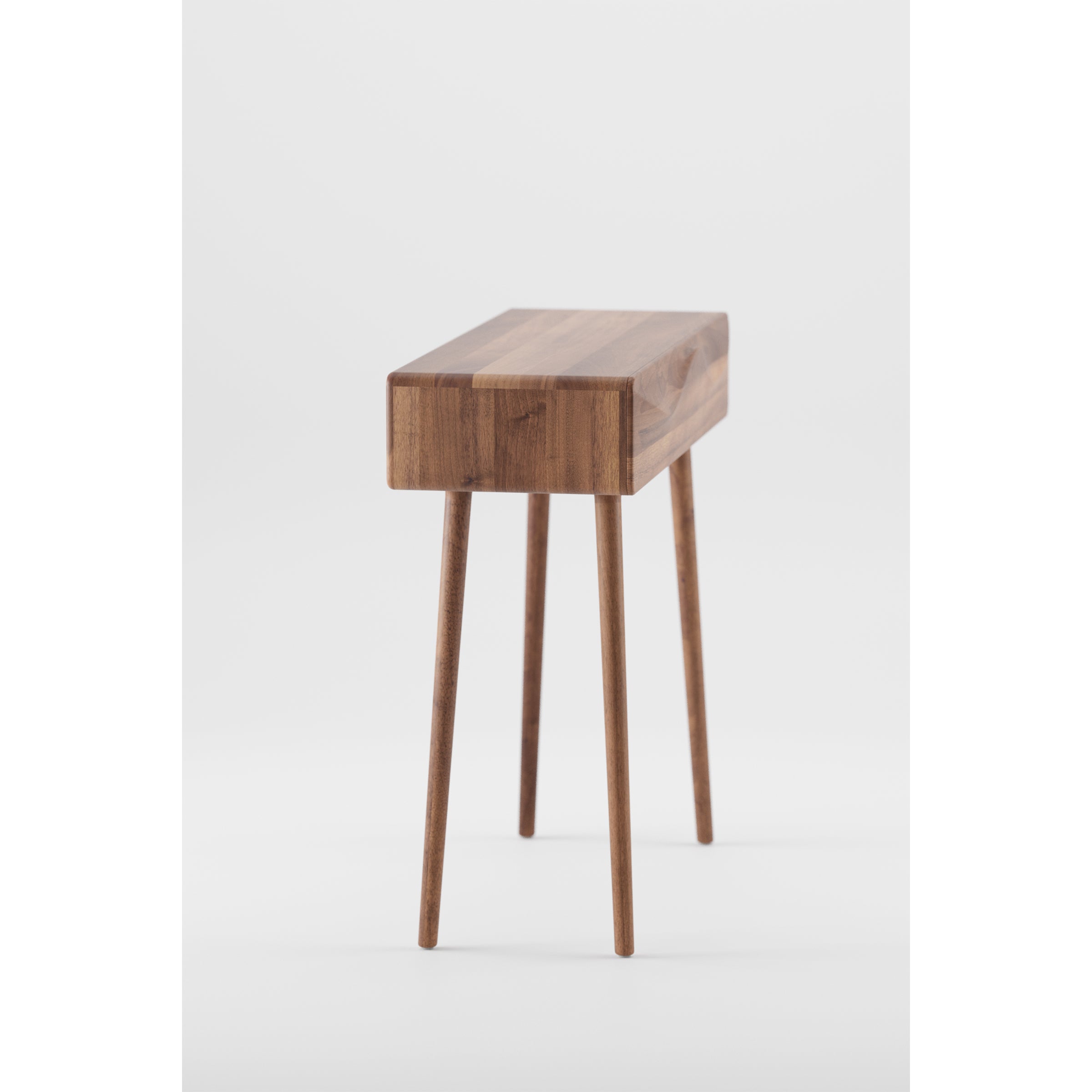 The LASTA Console Table by Artisan is a minimalist piece made from solid wood, featuring a rectangular top and four slender legs. Its natural oil finish highlights the grain against a plain white background, emphasizing its eco-friendly materials.
