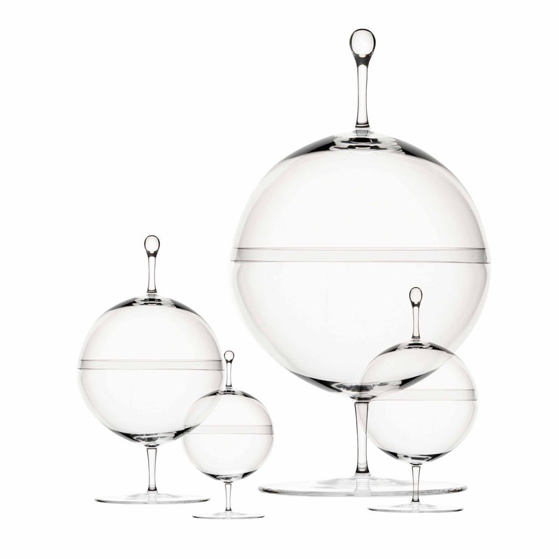 Lobmeyrs Candy Dish - Inventory features four exquisite glass jars with lids and spherical stems. Reminiscent of Oswald Haerdtls art, each transparent candy dish, crafted from mouth-blown lead-free crystal, varies in size from left to right.