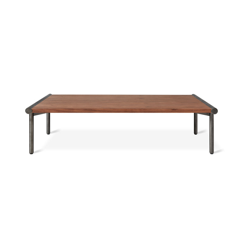 The Gus Modern Manifold Coffee Table Rectangle features a rectangular wooden top and four black metal legs, combining minimalist and modern design for a sleek, versatile centerpiece in any living space.